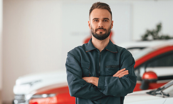 Image Showing Mechanic In Front of Cars