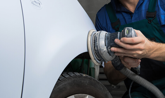 Image Showing Mechanic Buffing Vehicle Paint