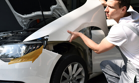 Image Of Mechanic Restoring Front End of Vehicle